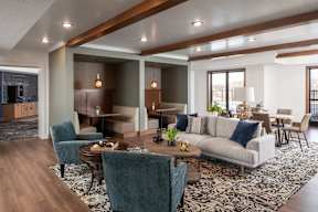 A modern living room with a large couch and a coffee table.