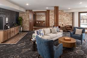 A living room with a sofa, armchair, and coffee table.
