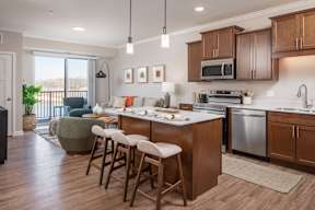 A kitchen with wooden cabinets and a dining table with chairs.