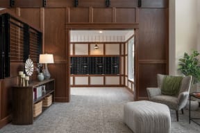 a hallway with a chair and a table and a wine cellar