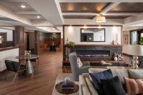 a living room with a fireplace and a table with chairs