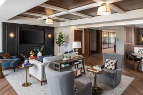 a living room with couches and chairs and a television