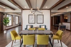 a dining room with yellow chairs and a table