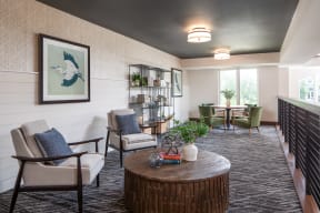a living room with chairs and a table