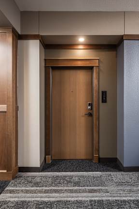 A wooden door with a handle and a lock is closed.