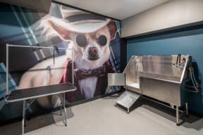 a mural of a dog wearing sunglasses and a hat on a wall behind a grill
