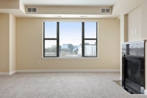 a large living room with a fireplace and a large window