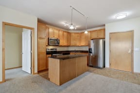a kitchen with wooden cabinets and an island