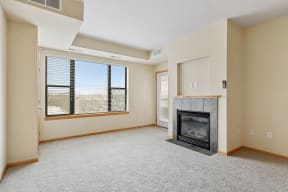 a living room with a fireplace and a large window
