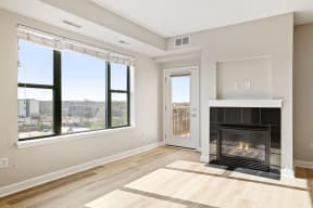 an spacious living room with a fireplace and large windows