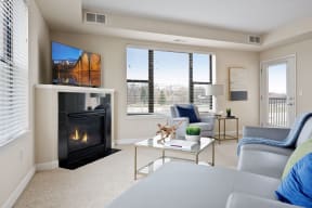 a living room with a fireplace and a large window