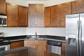 a kitchen with wooden cabinets and stainless steel appliances