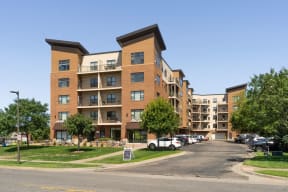 view of apartment complex with a parking lot in the foreground