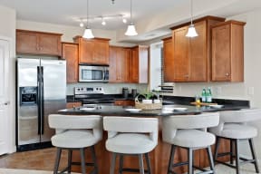 kitchen with brown cabinets stainless steel appliances and an island