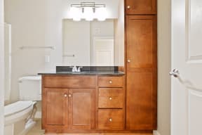 a bathroom with a toilet sink and mirror