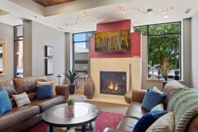 community room with couches a coffee table and a fireplace