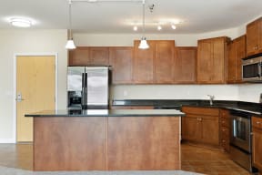 a kitchen with wooden cabinets and granite countertops