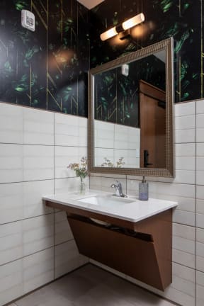 a bathroom with a white sink and a mirror