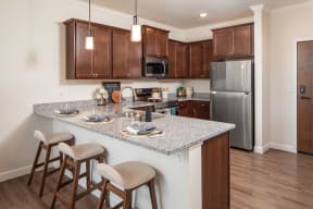 a kitchen with granite counter tops and stainless steel appliances