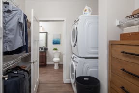 a laundry room with a washer and dryer and a bathroom with a toilet