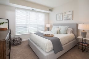 a bedroom with a bed and a large window