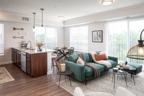 a living room with a couch and a kitchen with a table and chairs