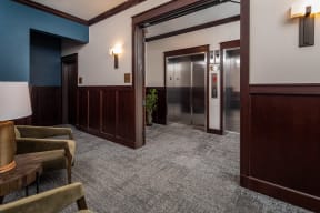 View of double elevators and sitting area at The Whitley apartments.