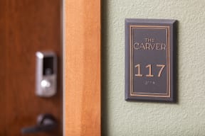 a hotel room door with a sign that says the carpeter