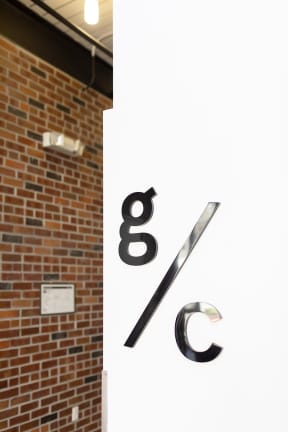 a large white sign with the letters g and c on it