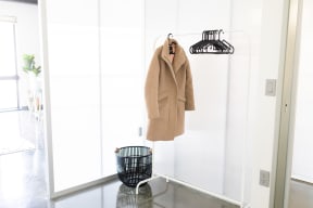 a coat hanging on a hanger in a white closet