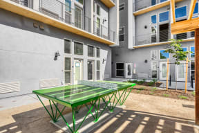 a ping pong table in front of an apartment building