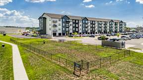 A large apartment complex with a playground in front.