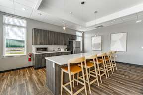A kitchen with a long table and chairs.