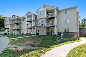 Apartment complex with multiple balconies and doors.