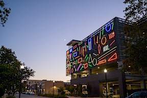 A building with a large neon sign on it.