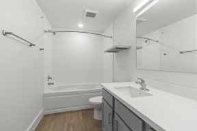 Bathrooms with custom quartz countertops and large soaking tubs at G at Market in Bentonville, AR