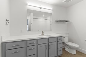 Bathrooms with custom quartz countertops and large soaking tubs at G at Market in Bentonville, AR