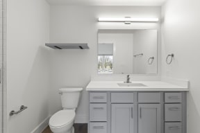 Bathrooms with custom quartz countertops and large soaking tubs at G at Market in Bentonville, AR