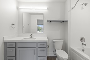 Bathrooms with custom quartz countertops and large soaking tubs at G at Market in Bentonville, AR