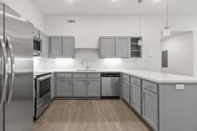 Large open kitchens with custom quartz countertops at G at Market in Bentonville, AR