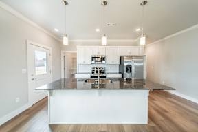 Two and three-bedroom townhomes featuring premium appliances, LVT flooring, garages, custom countertops, custom cabinetry and more at Hawthorne Grove in Rogers, AR
