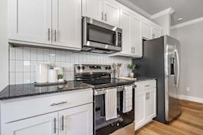 Two and three-bedroom townhomes featuring premium appliances, LVT flooring, garages, custom countertops, custom cabinetry and more at Hawthorne Grove in Rogers, AR