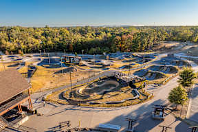 A skate park with ramps and a small building.