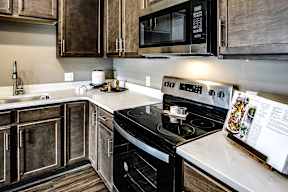 Kitchen with stainless steel appliances at Sterling Prairie Trail in Ankeny, IA