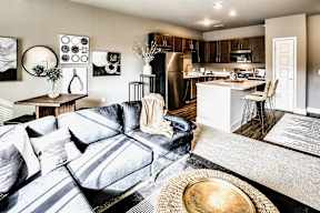 Modern living room with natural lighting at Sterling at Prairie Trail in Ankeny, IA