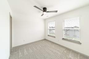 Bedroom with multiple windows at The Grove in Rogers, AR