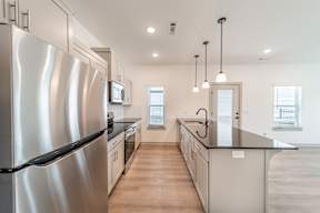 Kitchen with stainless steel appliances at The Grove in Rogers, AR
