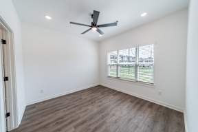 Bedroom with large window at The Grove in Rogers, AR