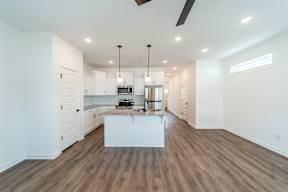 Spacious living room and kitchen area at The Grove in Rogers, AR