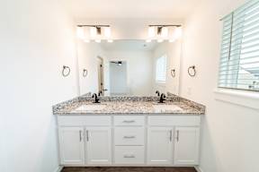 Bathroom with granite countertops at The Grove in Rogers, AR
